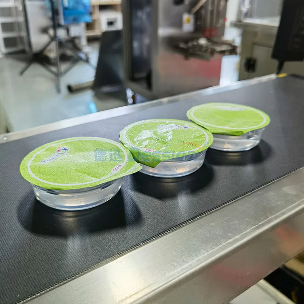 Small Automatic Honey Spoon/Ketchup/Sauce/Oil/Liquid/Lotion/Shampoo/Jelly/Liquid Soap/Juice/Tomato Paste Food Cup Packaging Packing Filling Sealing Machine